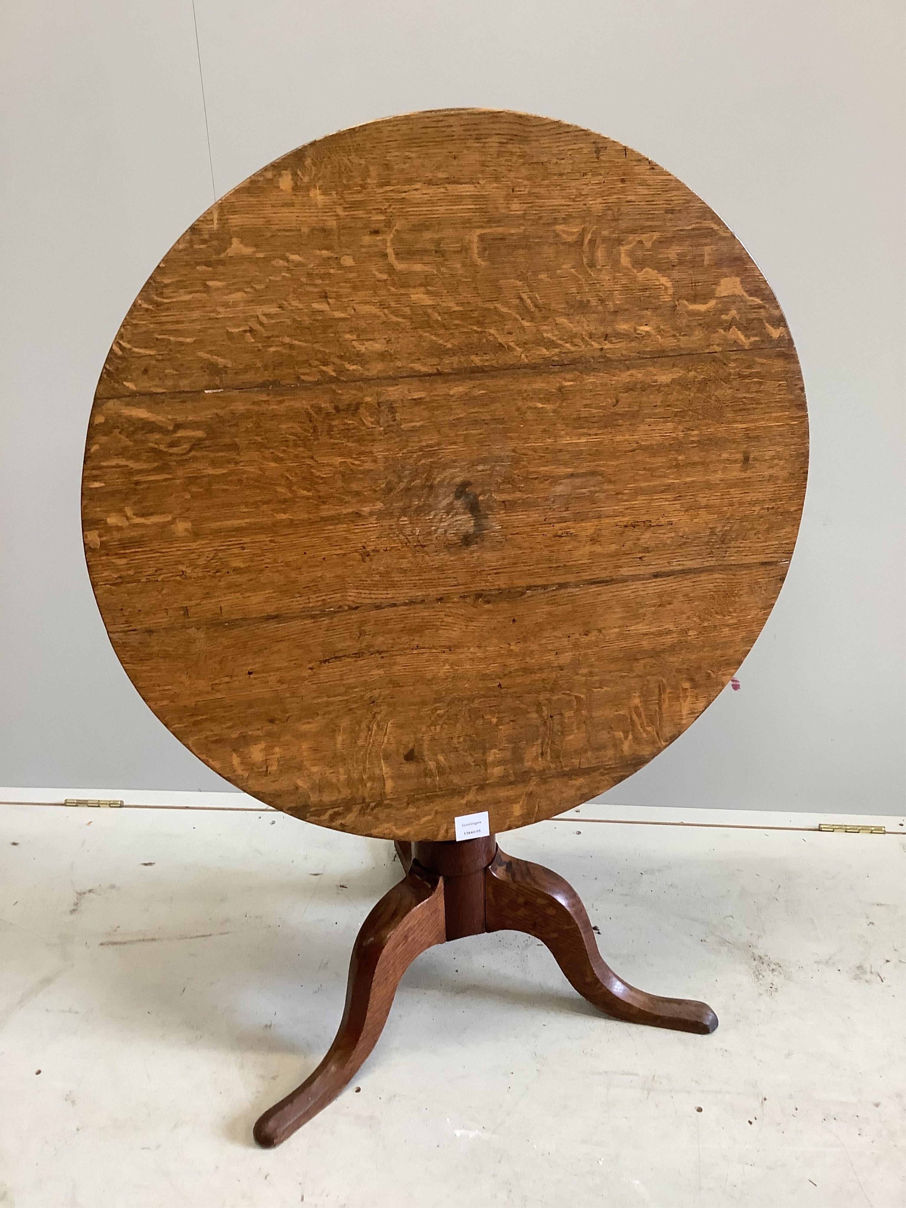 A George III oak tripod table, diameter 78cm, height 71cm. Condition - fair to good